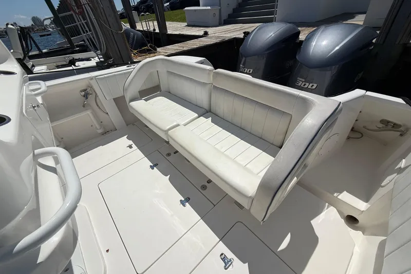 Slide: The Image of 2013 Intrepid 327 Cuddy boat interior with seating and dual Yamaha 300 engines. - 26