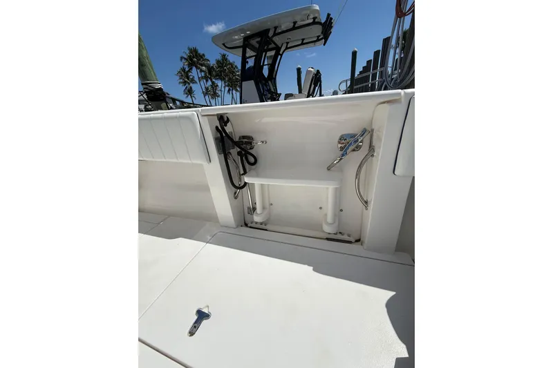 Slide: The Image of 2013 Intrepid 327 Cuddy boat deck with storage compartment and equipment. - 27