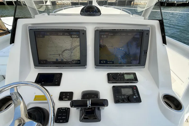 Slide: The Image of Control panel of a 2013 Intrepid 327 Cuddy boat with navigation screens and controls. - 29