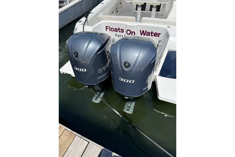 Slide: The Image of Twin Yamaha 300 engines on a 2013 Intrepid 327 Cuddy boat at dock. - 30