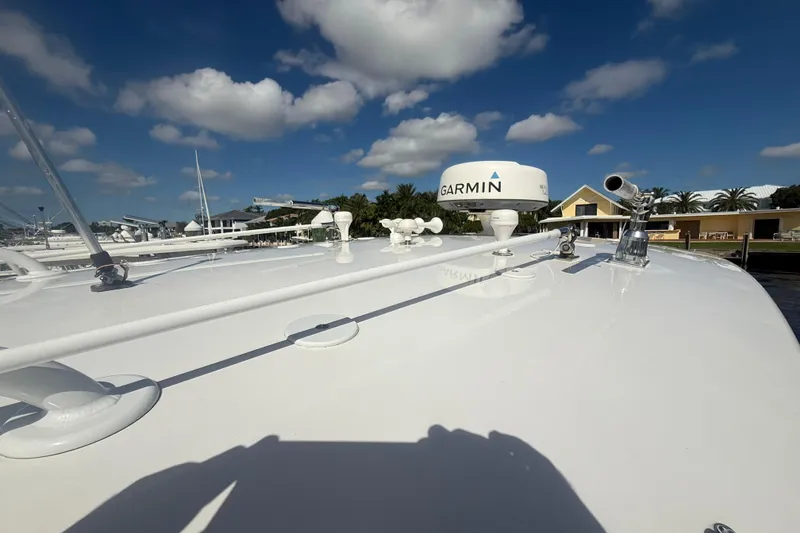 Slide: The Image of 2013 Intrepid 327 Cuddy boat with Garmin radar under a clear blue sky. - 6