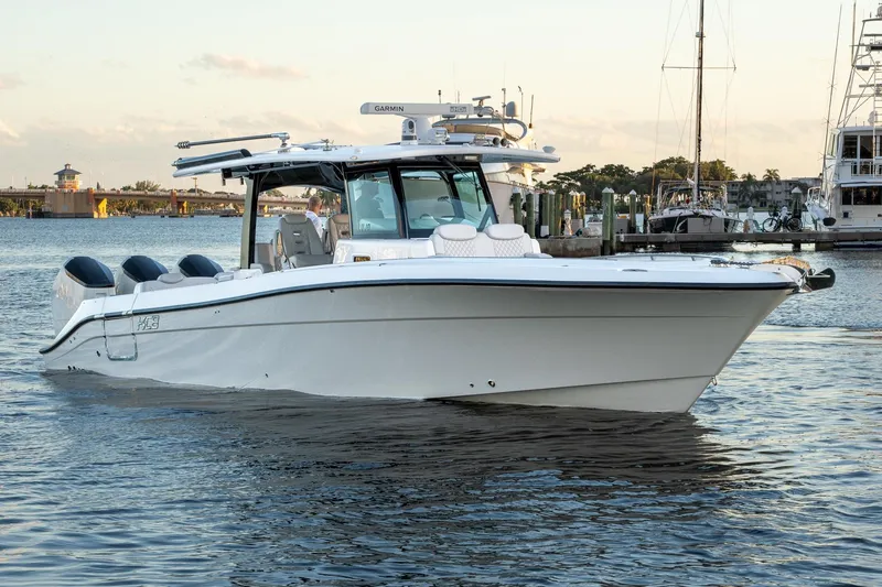 Slide: The Image of 2024 HCB 42 Lujo boat on calm water, showcasing sleek design and powerful engines. - 1