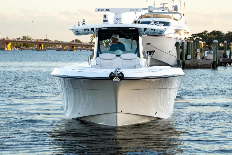 Slide: The Image of 2024 HCB 42 Lujo boat cruising on open water, showcasing sleek design and modern features. - 2