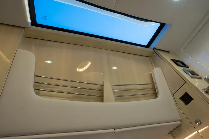 Slide: The Image of 2024 HCB 42 Lujo boat interior with sleek kitchen setup and water view. - 27