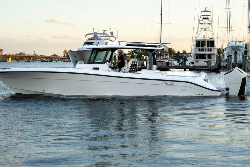 Slide: The Image of 2024 HCB 42 Lujo boat with triple engines on calm water. - 3