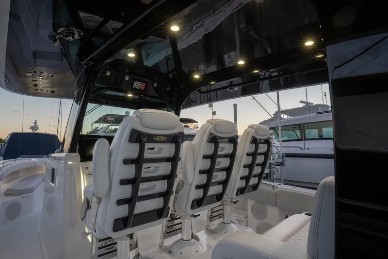 Slide: The Image of 2024 HCB 42 Lujo boat interior with quilted seating and cup holders. - 38