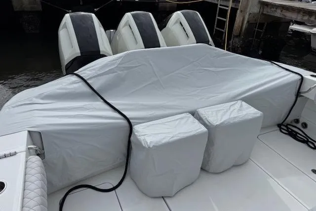 Slide: The Image of 2024 HCB 42 Lujo boat helm covered with a protective gray tarp. - 48