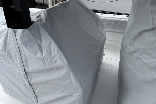 Slide: The Image of 2024 HCB 42 Lujo boat covered at marina, surrounded by other yachts. - 50