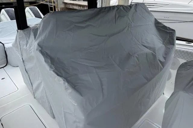 Slide: The Image of 2024 HCB 42 Lujo boat canopy with scenic lake and forest backdrop. - 51