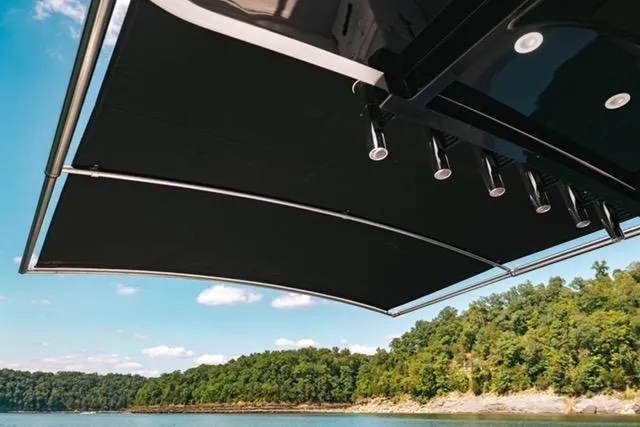 Slide: The Image of 2024 HCB 42 Lujo boat interior with advanced navigation system, overlooking serene waterway. - 55