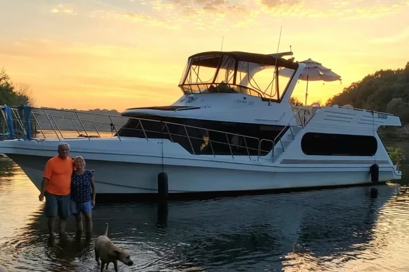 The Image of 1992 Bluewater 54 Coastal Cruiser at sunset with people and dog nearby. - 1