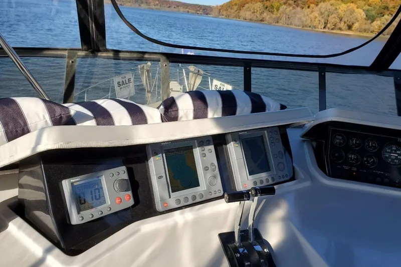 Slide: The Image of Cockpit view of 1992 Bluewater 54 Coastal Cruiser with navigation instruments and lake scenery. - 11