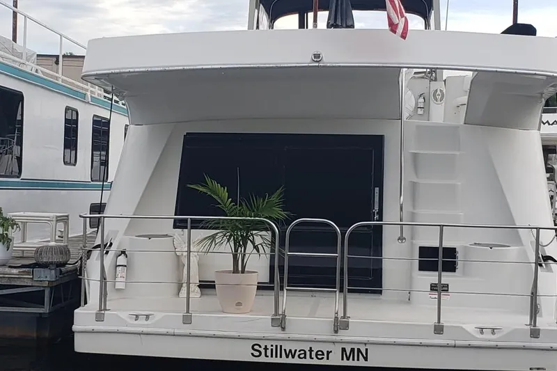 Slide: The Image of 1992 Bluewater 54 Coastal Cruiser docked in Stillwater, MN with potted plant on deck. - 13