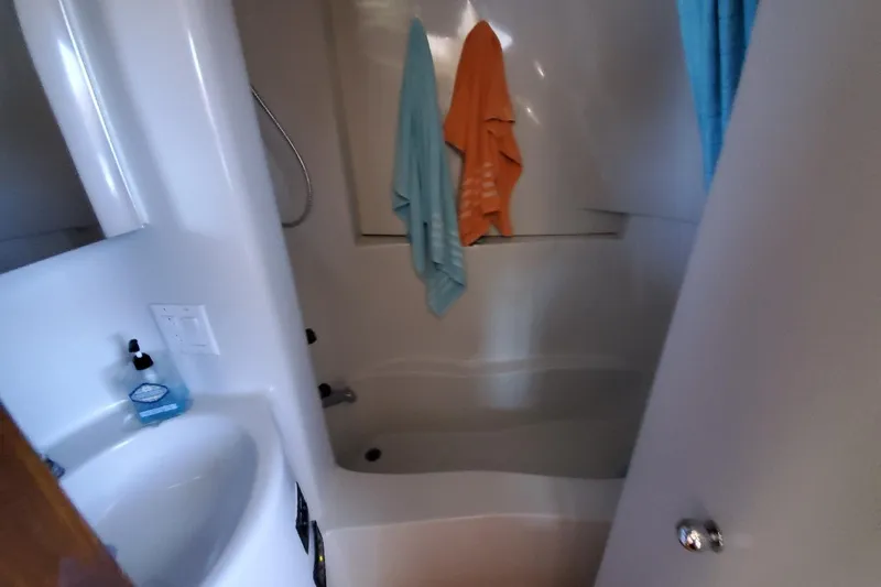 Slide: The Image of Bathroom interior of 1992 Bluewater 54 Coastal Cruiser with towels and sink. - 8