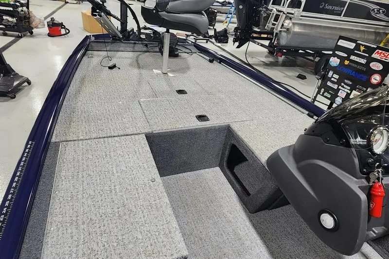 Slide: The Image of 2021 Tracker Pro 170 boat interior with gray carpet and steering console. - 3