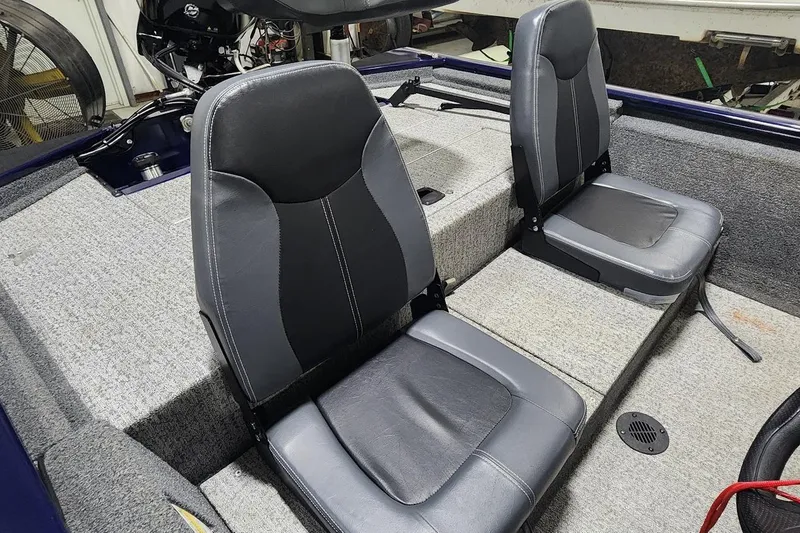 Slide: The Image of 2021 Tracker Pro 170 boat interior with two gray seats and carpeted flooring. - 6