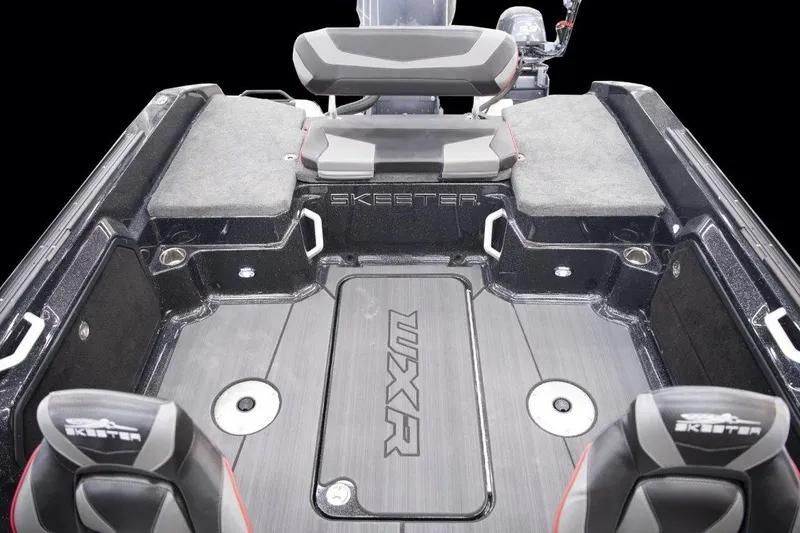 Slide: The Image of 2025 Skeeter WXR2260 boat interior with fishing rod holders, under a clear blue sky. - 4
