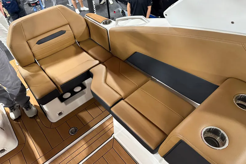 Slide: The Image of Luxurious seating on 2026 Yamaha Boats 295SD, featuring tan upholstery and cup holders. - 10