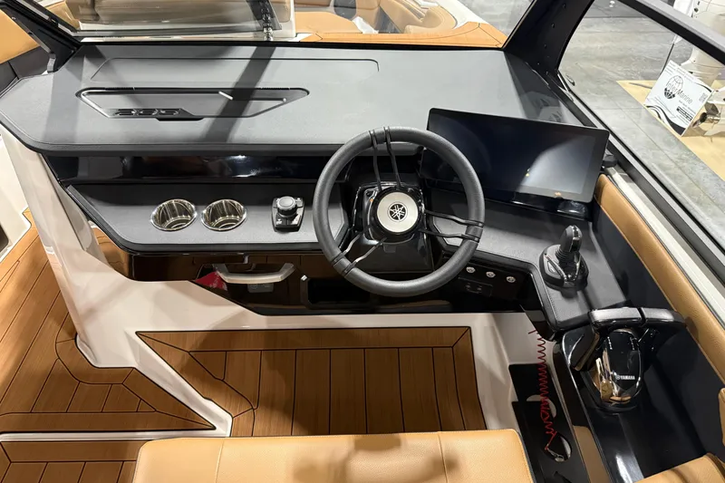 Slide: The Image of 2026 Yamaha Boats 295SD helm with steering wheel, touchscreen, and joystick controls. - 12
