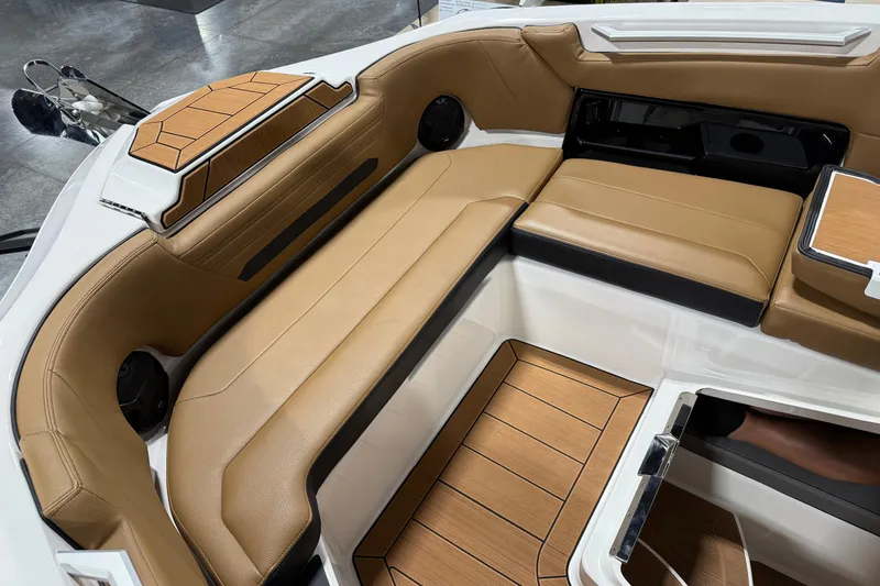 Slide: The Image of 2026 Yamaha Boats 295SD interior with tan leather seating and wood accents. - 14