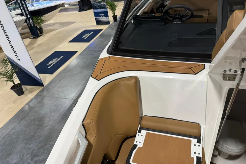 Slide: The Image of 2026 Yamaha Boats 295SD interior with tan leather seating and modern dashboard. - 15