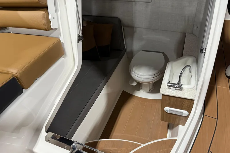 Slide: The Image of 2026 Yamaha Boats 295SD interior with toilet, sink, and seating area. - 17