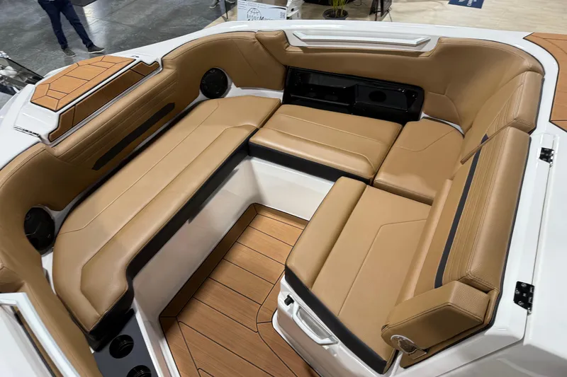 Slide: The Image of Luxurious seating area on 2026 Yamaha Boats 295SD with tan upholstery and sleek design. - 18