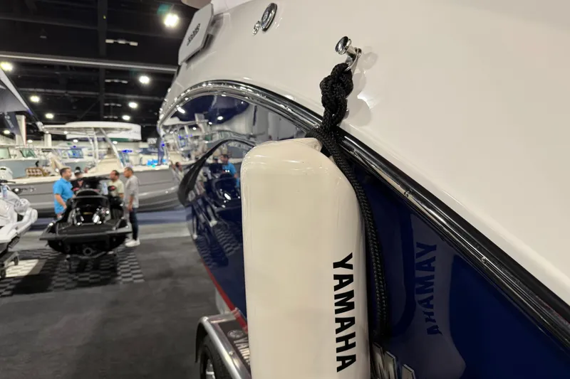 Slide: The Image of 2026 Yamaha Boats 295SD showcased at a boat exhibition, featuring sleek design and branding. - 20