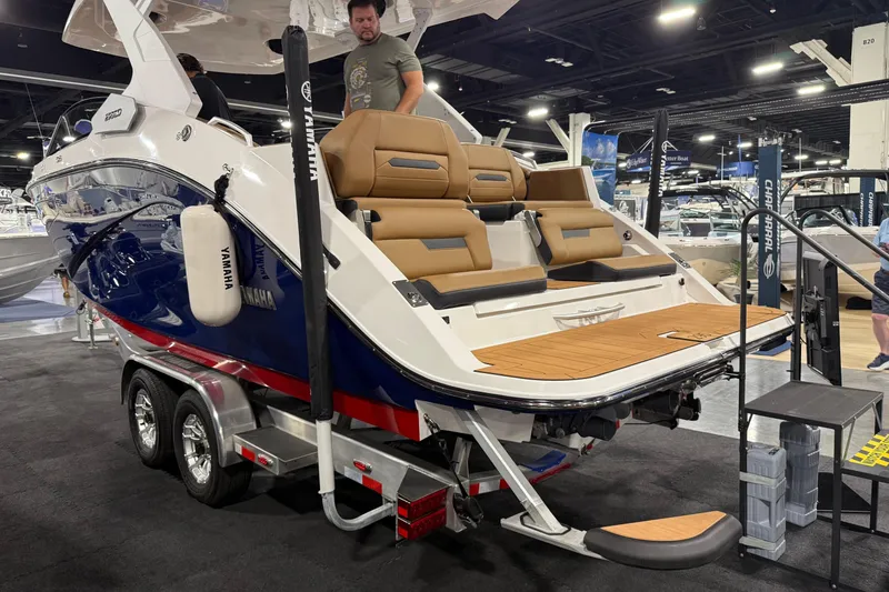 Slide: The Image of 2026 Yamaha Boats 295SD displayed at a boat show, featuring sleek design and luxury seating. - 3