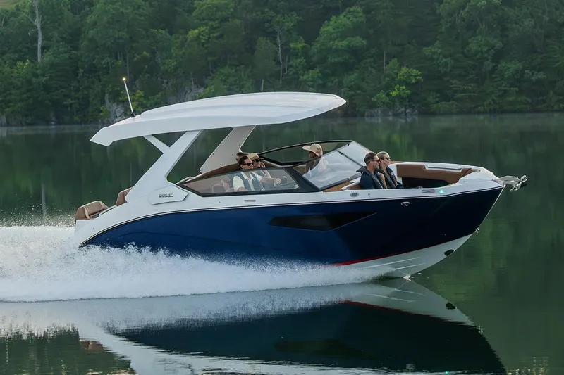 Slide: The Image of Manufacturer Provided Image: 2026 Yamaha Boats 295SD cruising on a serene lake with lush green surroundings. - 31