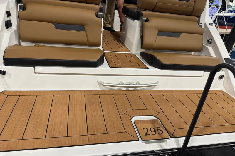Slide: The Image of 2026 Yamaha Boats 295SD interior with tan seating and wood-style flooring. - 5