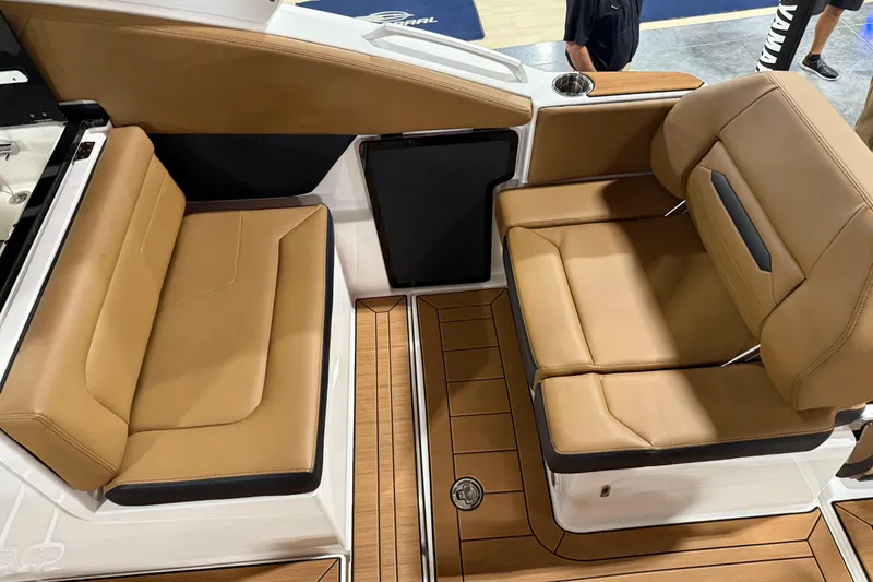 Slide: The Image of 2026 Yamaha Boats 295SD interior with tan leather seating and wood flooring. - 7