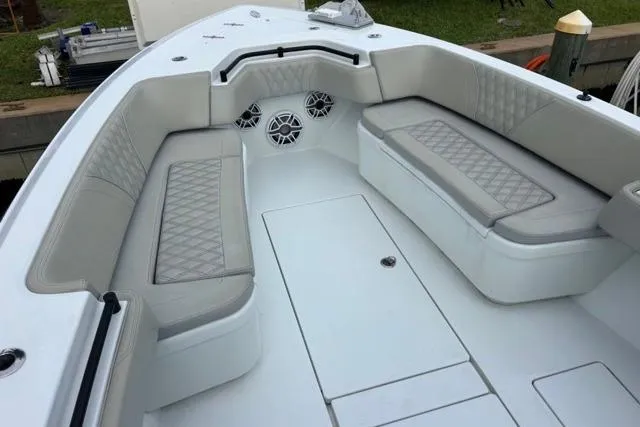Slide: The Image of 2023 Contender 32 ST boat interior with cushioned seating and speakers. - 10