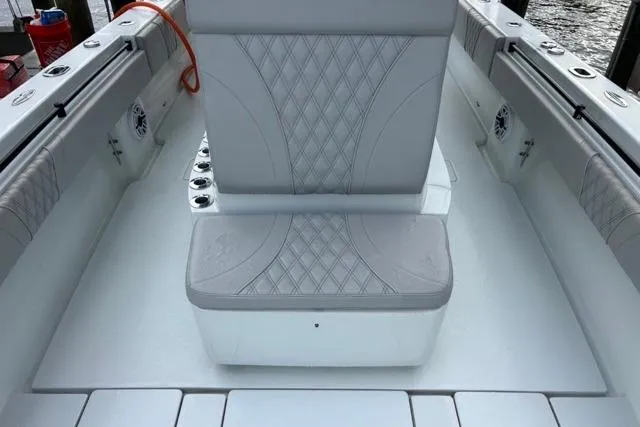 Slide: The Image of 2023 Contender 32 ST boat interior with diamond-stitched seating and rod holders. - 11
