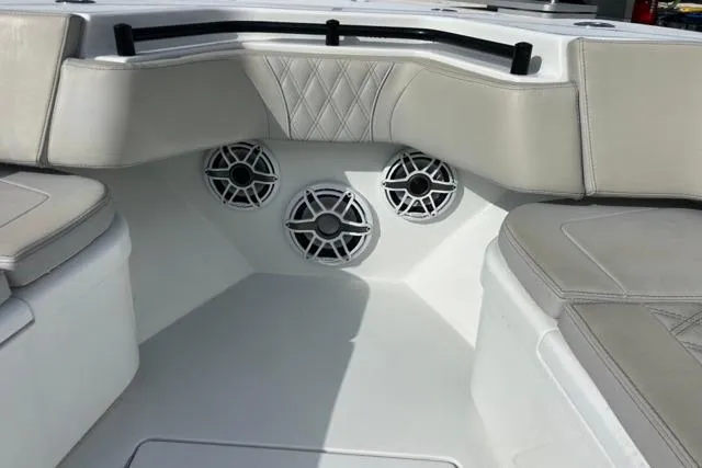 Slide: The Image of 2023 Contender 32 ST boat interior with cushioned seating and built-in speakers. - 14