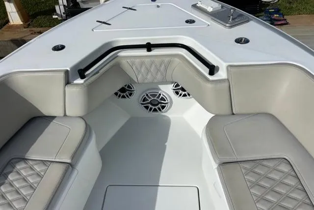 Slide: The Image of 2023 Contender 32 ST boat interior with cushioned seating and built-in speakers. - 15