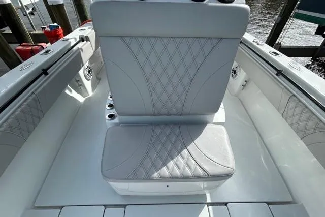 Slide: The Image of 2023 Contender 32 ST boat interior with stylish seating and diamond-pattern upholstery. - 16