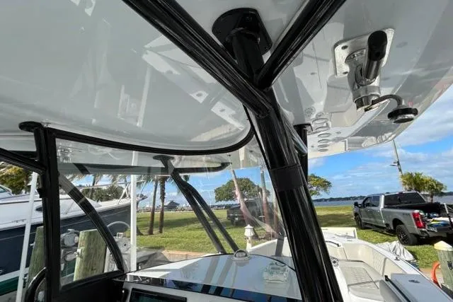 Slide: The Image of 2023 Contender 32 ST boat interior with sleek design and modern features, docked near a scenic waterfront. - 19