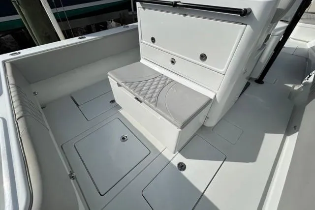 Slide: The Image of 2023 Contender 32 ST boat interior with cushioned seating and storage compartments. - 22