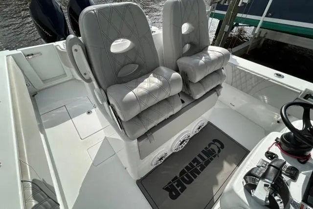 Slide: The Image of 2023 Contender 32 ST boat interior with cushioned seats and steering console. - 27