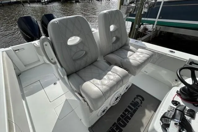 Slide: The Image of 2023 Contender 32 ST boat interior with dual cushioned seats and steering wheel. - 28