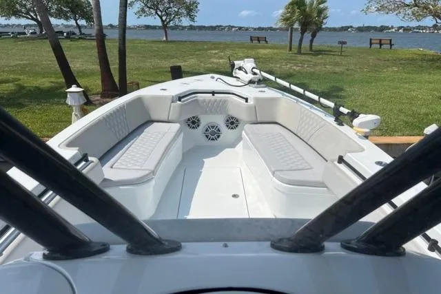 Slide: The Image of 2023 Contender 32 ST fishing boat docked with rods and American flag. - 3