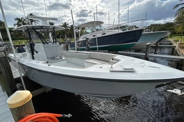 Slide: The Image of 2023 Contender 32 ST boat docked, sleek design, ready for adventure. - 32