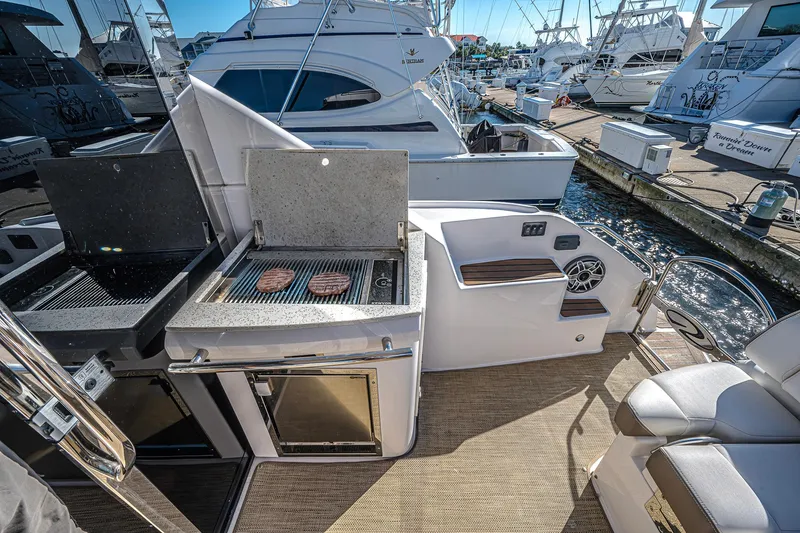 Slide: The Image of Outdoor grill on 2016 Regal 46 Sport Coupe yacht, docked at marina. - 11