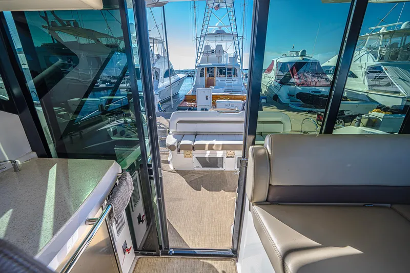 Slide: The Image of Interior view of 2016 Regal 46 Sport Coupe yacht with marina backdrop. - 12