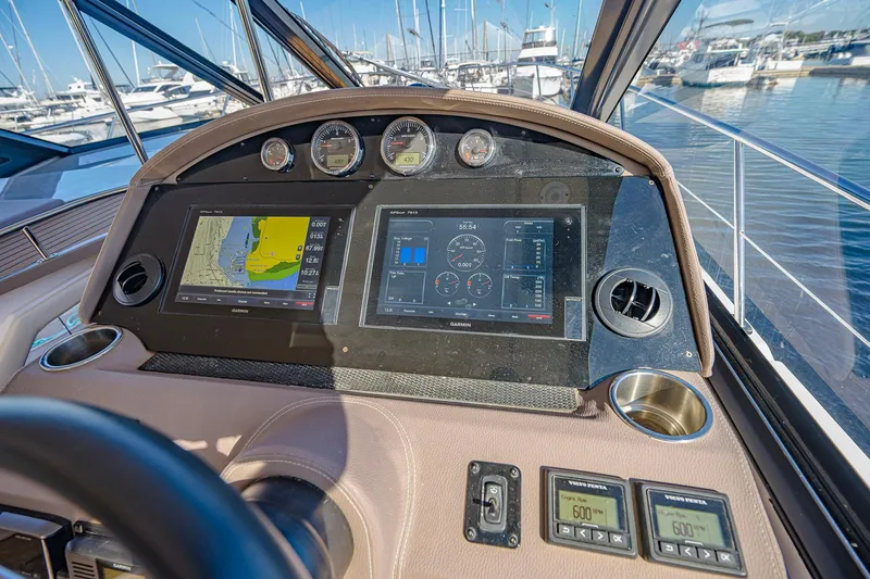 Slide: The Image of Dashboard of a 2016 Regal 46 Sport Coupe yacht with navigation screens and gauges. - 18