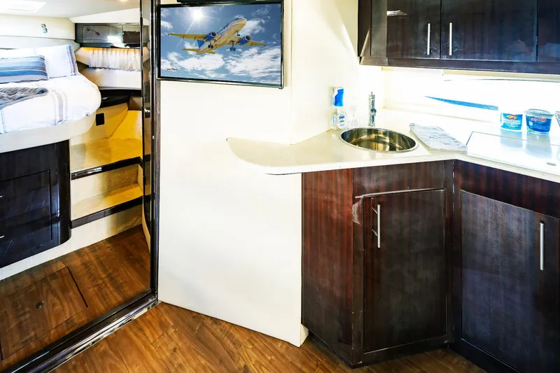 Slide: The Image of Interior of 2016 Regal 46 Sport Coupe with kitchenette and cozy sleeping area. - 23