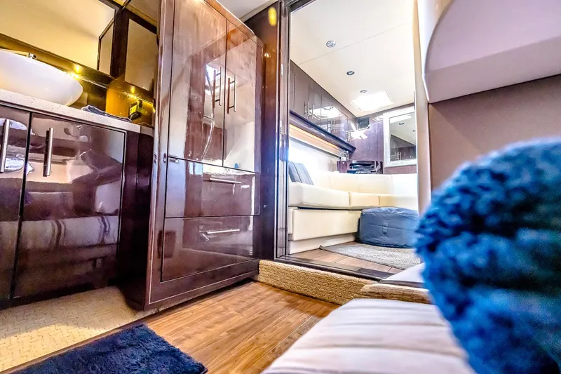 Slide: The Image of Luxurious interior of a 2016 Regal 46 Sport Coupe yacht, featuring elegant wood finishes. - 27