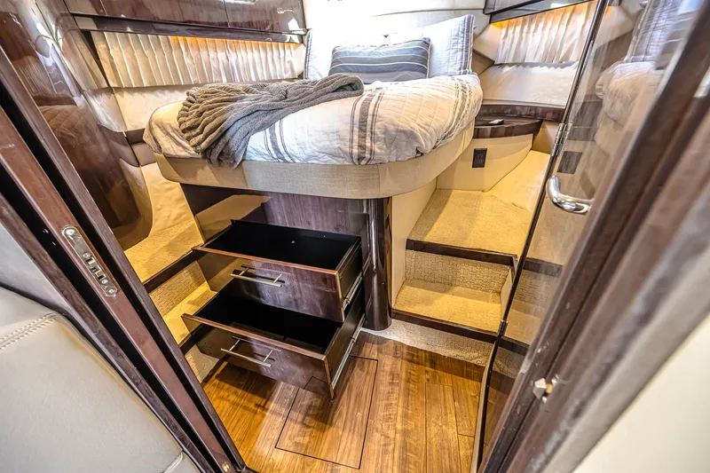 Slide: The Image of Luxurious cabin interior of 2016 Regal 46 Sport Coupe with bed and storage drawers. - 30