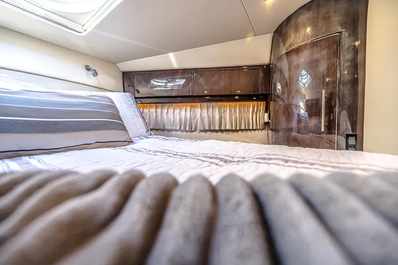 Slide: The Image of Luxurious interior cabin of 2016 Regal 46 Sport Coupe yacht with elegant bedding. - 31